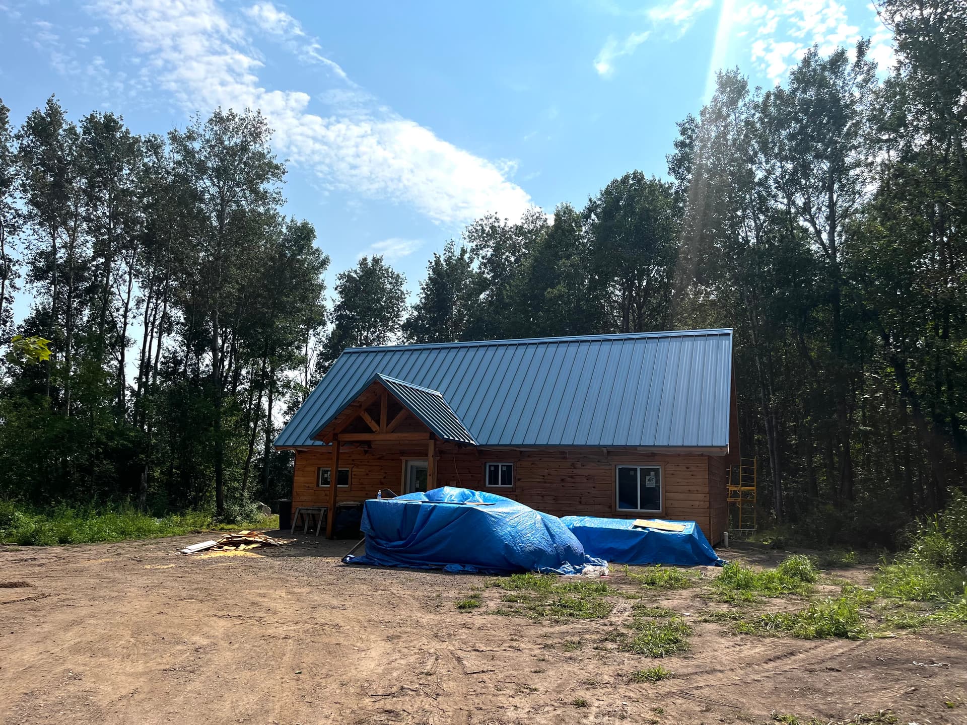 Standing Seam Metal Roof With Custom Fascia on a Log Cabin image